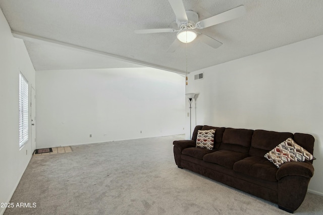 carpeted living room with ceiling fan and a textured ceiling