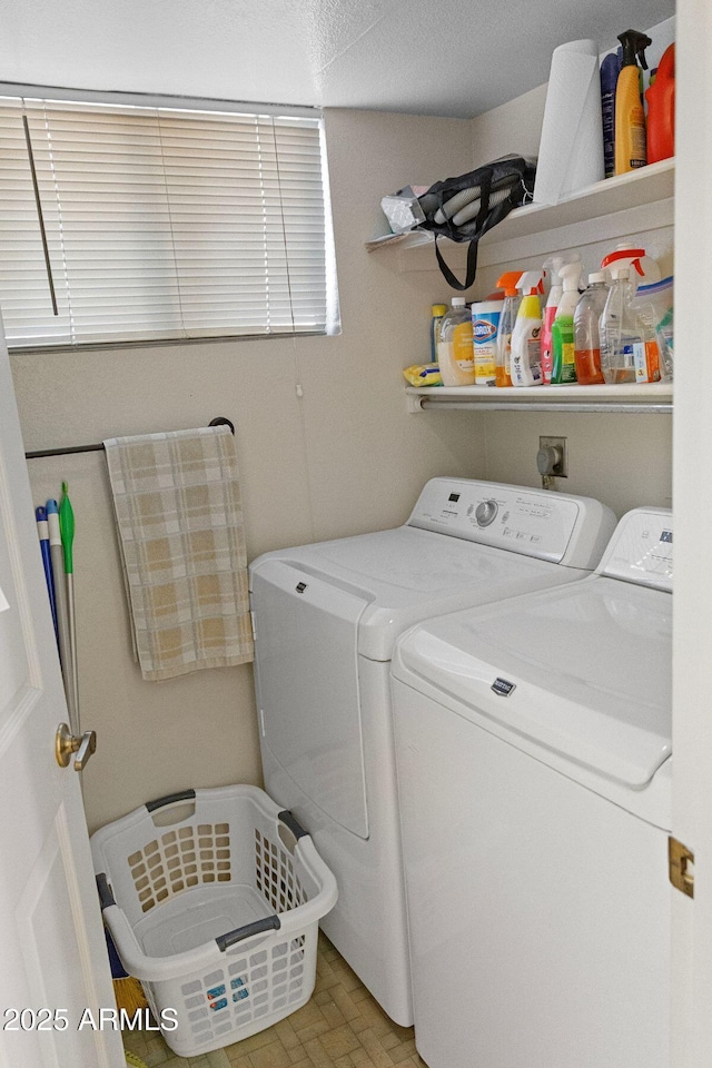 clothes washing area with washing machine and clothes dryer