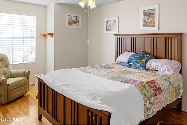 bedroom with hardwood / wood-style flooring and a textured ceiling