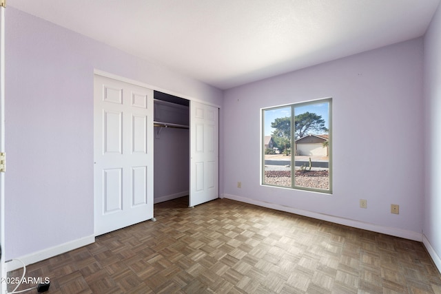 unfurnished bedroom featuring dark parquet flooring