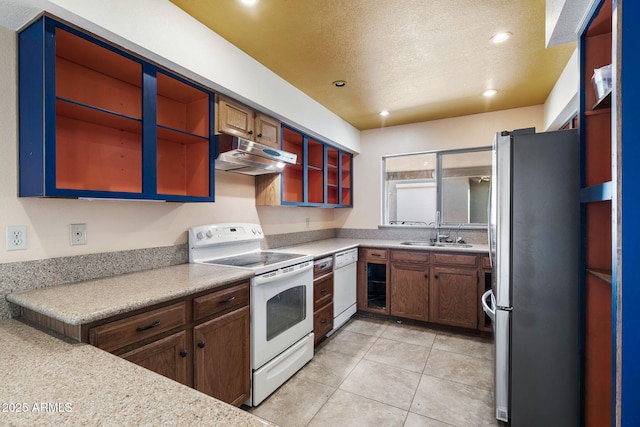 kitchen with white appliances, sink, and light tile patterned floors