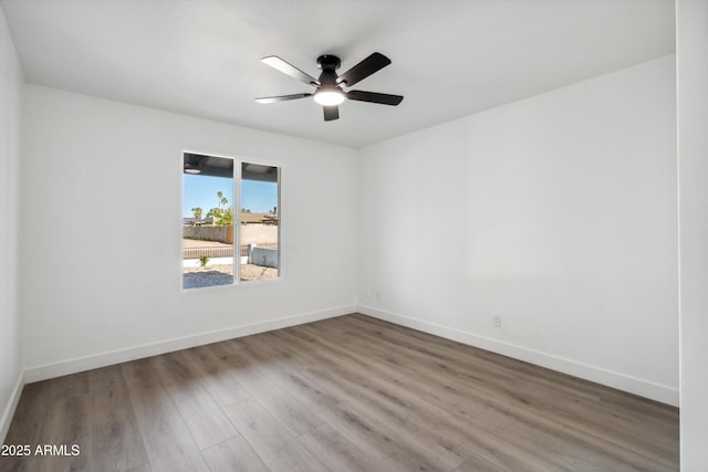 2922 S Juniper St, Tempe, AZ 85282 - unfurnished room featuring baseboards, a ceiling fan, and wood finished floors