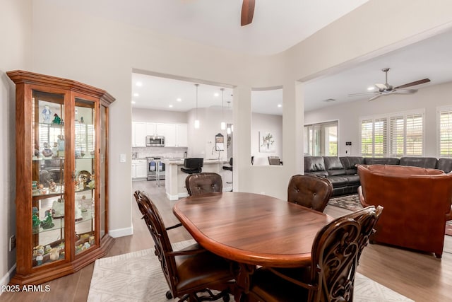 dining room with recessed lighting, light wood-type flooring, and a ceiling fan