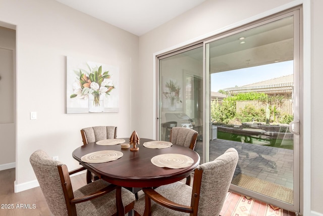 dining area with wood finished floors and baseboards