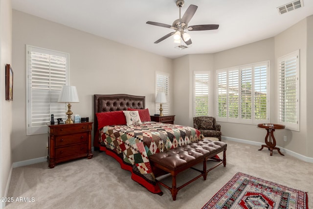 carpeted bedroom with visible vents, ceiling fan, and baseboards