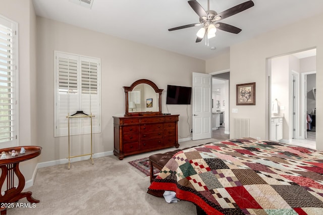 bedroom with visible vents, carpet flooring, connected bathroom, and baseboards