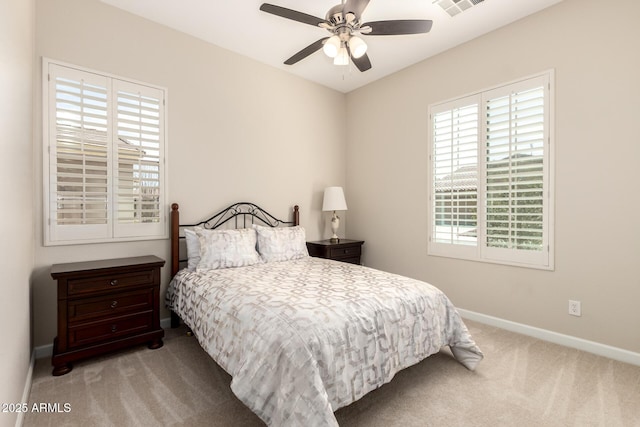 carpeted bedroom featuring visible vents, baseboards, and ceiling fan