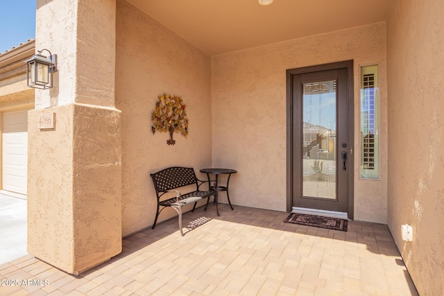 doorway to property featuring stucco siding