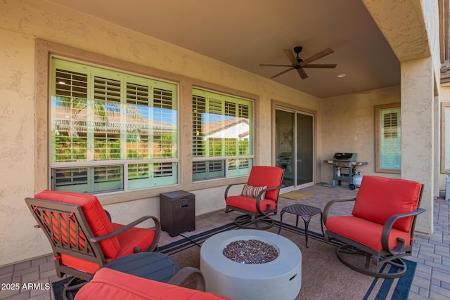 view of patio / terrace with grilling area, ceiling fan, and an outdoor fire pit