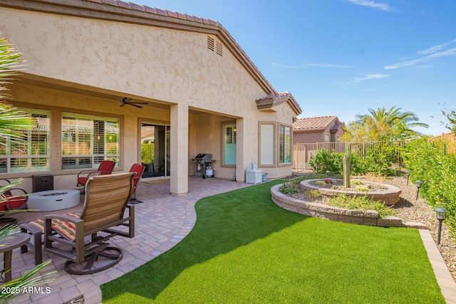 view of yard featuring a patio, a ceiling fan, and fence