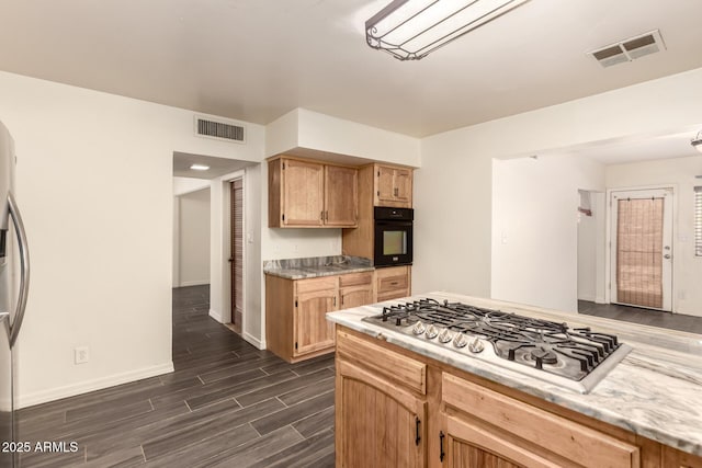 18049 N 13th Ave, Phoenix, AZ 85023 - kitchen featuring stainless steel gas stovetop, black oven, dark wood finished floors, and light countertops