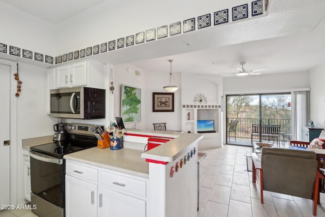 kitchen featuring open floor plan, a peninsula, stainless steel appliances, white cabinetry, and light tile patterned flooring