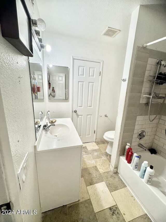 3840 N 43rd Ave Unit 29, Phoenix, AZ 85031 - full bathroom featuring tiled shower / bath combo, toilet, and vanity