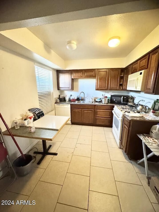 3840 N 43rd Ave Unit 29, Phoenix, AZ 85031 - kitchen with white appliances, sink, and light tile patterned floors
