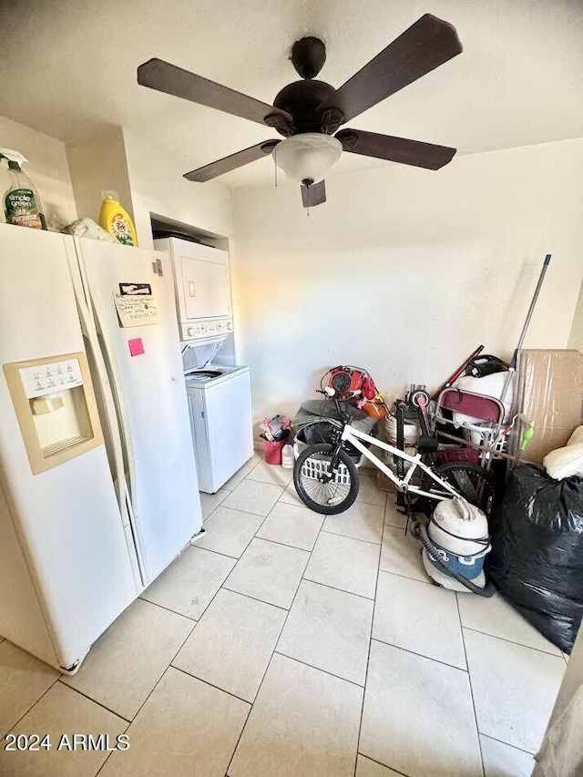 3840 N 43rd Ave Unit 29, Phoenix, AZ 85031 - kitchen featuring light tile patterned floors, stacked washer and dryer, white fridge with ice dispenser, and ceiling fan