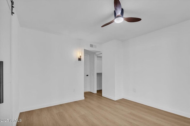 unfurnished room with visible vents, baseboards, light wood-style floors, and ceiling fan