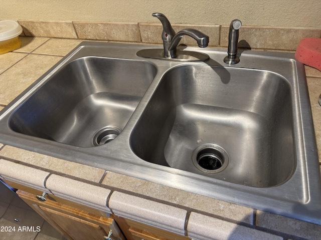 room details featuring tile counters and sink