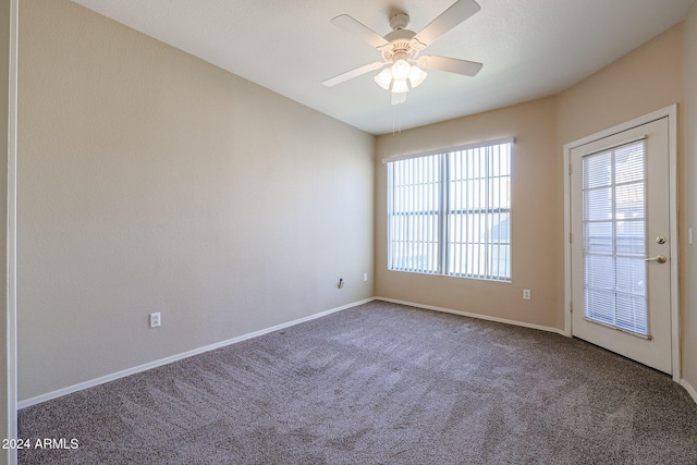 empty room featuring carpet flooring and ceiling fan