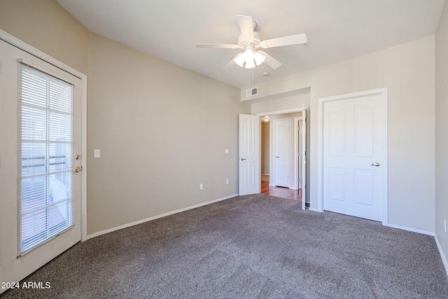 carpeted spare room with ceiling fan