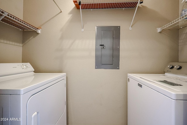 laundry area featuring electric panel and washing machine and clothes dryer