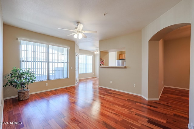 spare room featuring hardwood / wood-style floors, ceiling fan, and a textured ceiling