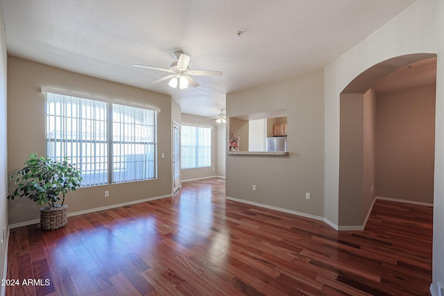14950 W Mountain View Blvd Unit 1310, Surprise, AZ 85374 - spare room featuring arched walkways, ceiling fan, wood finished floors, and baseboards
