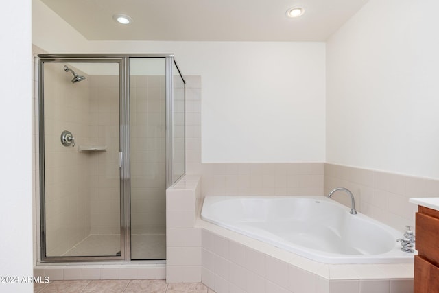 bathroom with vanity, shower with separate bathtub, and tile flooring