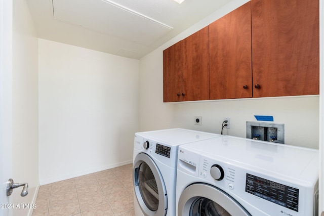 laundry room featuring washer and dryer, electric dryer hookup, hookup for a washing machine, light tile floors, and cabinets