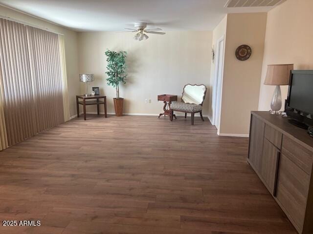 sitting room featuring visible vents, dark wood finished floors, baseboards, and ceiling fan