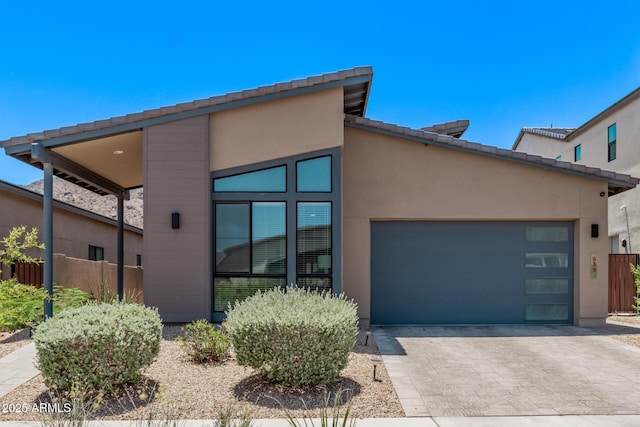 939 E Paseo Way, Phoenix, AZ 85042 - view of front of property with a garage, driveway, and stucco siding