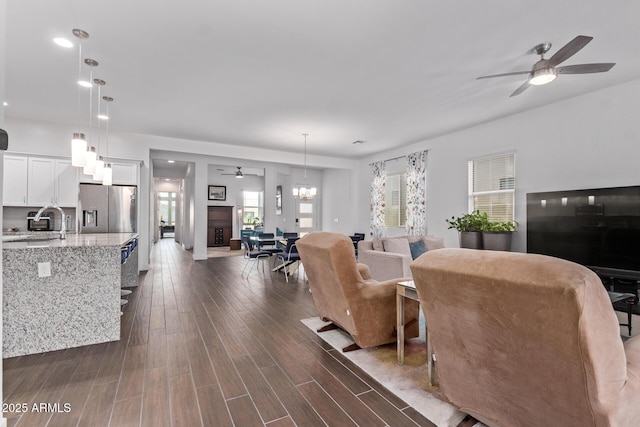 939 E Paseo Way, Phoenix, AZ 85042 - living room featuring dark wood-type flooring, ceiling fan, and plenty of natural light