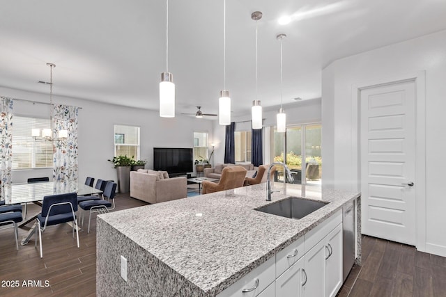 939 E Paseo Way, Phoenix, AZ 85042 - kitchen featuring a sink, dark wood-style flooring, pendant lighting, and light stone countertops