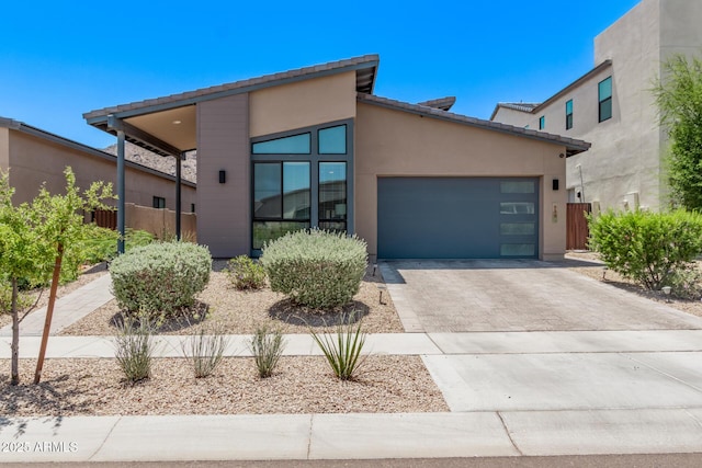 939 E Paseo Way, Phoenix, AZ 85042 - view of front of property with concrete driveway, a garage, and stucco siding