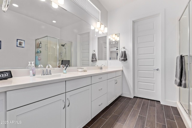 939 E Paseo Way, Phoenix, AZ 85042 - full bathroom with double vanity, a stall shower, wood finished floors, and recessed lighting