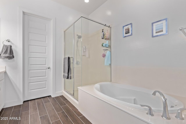 939 E Paseo Way, Phoenix, AZ 85042 - full bathroom with a stall shower, a garden tub, vanity, and wood finish floors