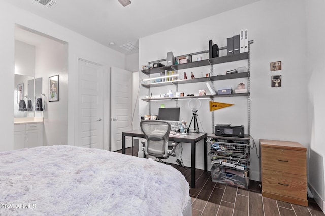 939 E Paseo Way, Phoenix, AZ 85042 - bedroom with wood finish floors, baseboards, an office area, and ensuite bath