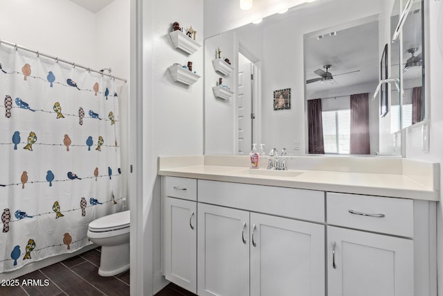 939 E Paseo Way, Phoenix, AZ 85042 - bathroom with toilet, a ceiling fan, vanity, and a shower with curtain