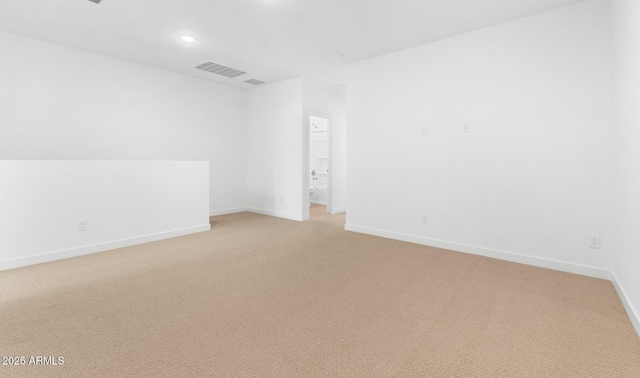 spare room with baseboards, recessed lighting, visible vents, and light colored carpet