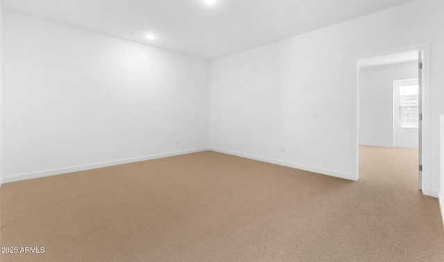 unfurnished room with baseboards, recessed lighting, and light colored carpet