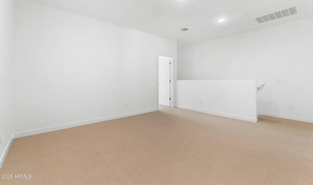 unfurnished room with light colored carpet, visible vents, baseboards, and recessed lighting