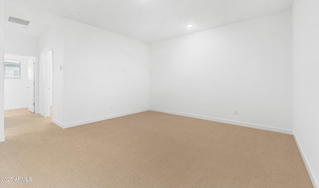 unfurnished room featuring light carpet, baseboards, visible vents, and recessed lighting