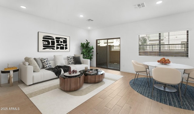 living area featuring recessed lighting, visible vents, and light wood finished floors