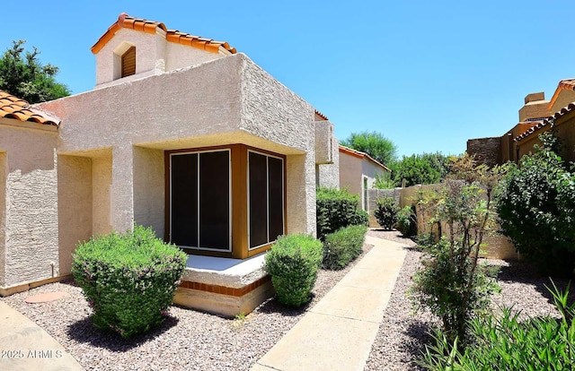9235 N 101st St, Scottsdale, AZ 85258 - view of property exterior with stucco siding and a tile roof