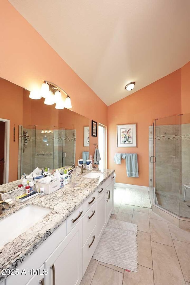 9235 N 101st St, Scottsdale, AZ 85258 - full bath with vaulted ceiling, double vanity, a shower stall, and tile patterned floors