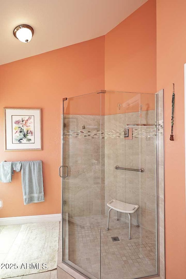 9235 N 101st St, Scottsdale, AZ 85258 - bathroom featuring a shower stall, vaulted ceiling, and tile patterned flooring