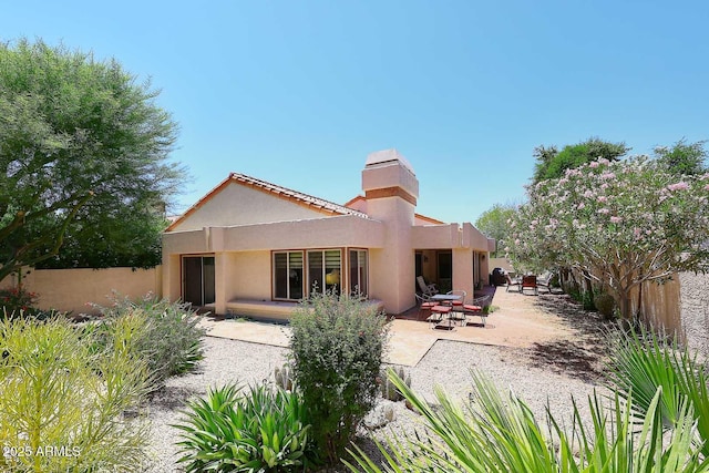9235 N 101st St, Scottsdale, AZ 85258 - rear view of property featuring a patio, stucco siding, and a chimney