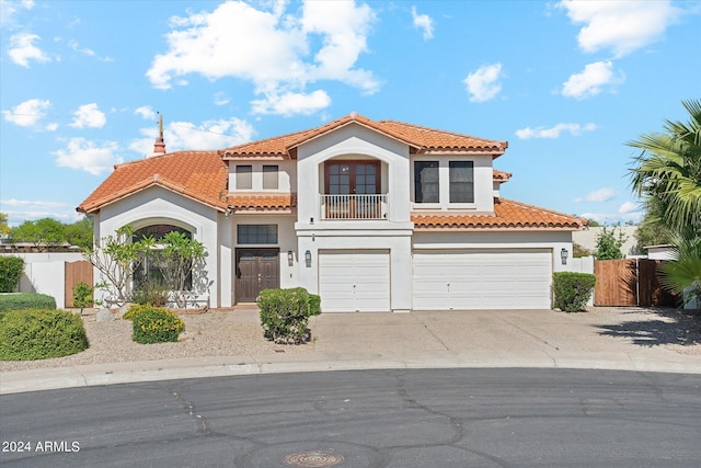 mediterranean / spanish home featuring a garage