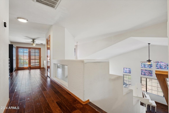 hall featuring vaulted ceiling and dark hardwood / wood-style flooring