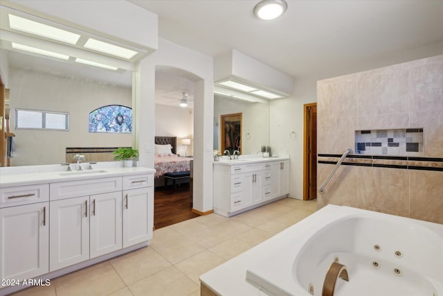 bathroom with vanity, ceiling fan, a bathing tub, and tile patterned floors