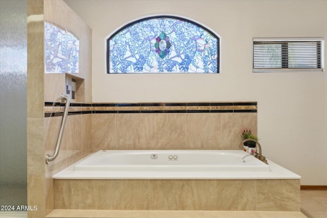 bathroom with tiled bath and tile patterned floors